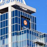 Men work to install the PNC Bank sign on the former RBC Plaza