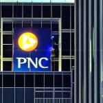 Workers on Raleigh's PNC Bank sign at night