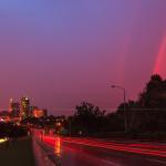 Surreal scene over Raleigh with rainbow and setting sun after a storm