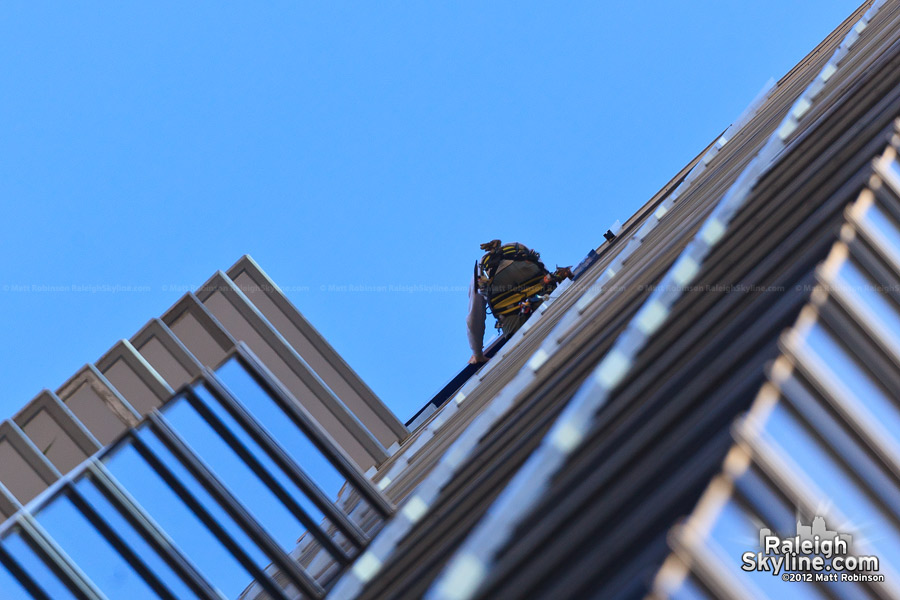 A man works on replacement the RBC Sign in Raleigh