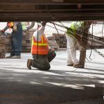 Workers check the platform on which the SunTrust Tower rolls into Raleigh