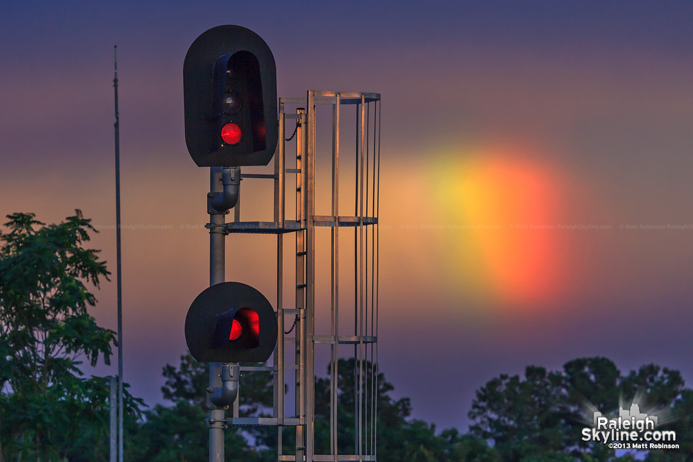 Rainbow behind railroad signal