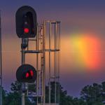 Rainbow behind railroad signal