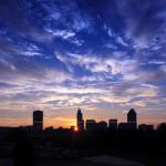 Sunrise burst behind Raleigh buildings