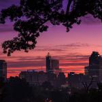 Pink and purple sunrise with the Raleigh skyline from Dorothea Dix