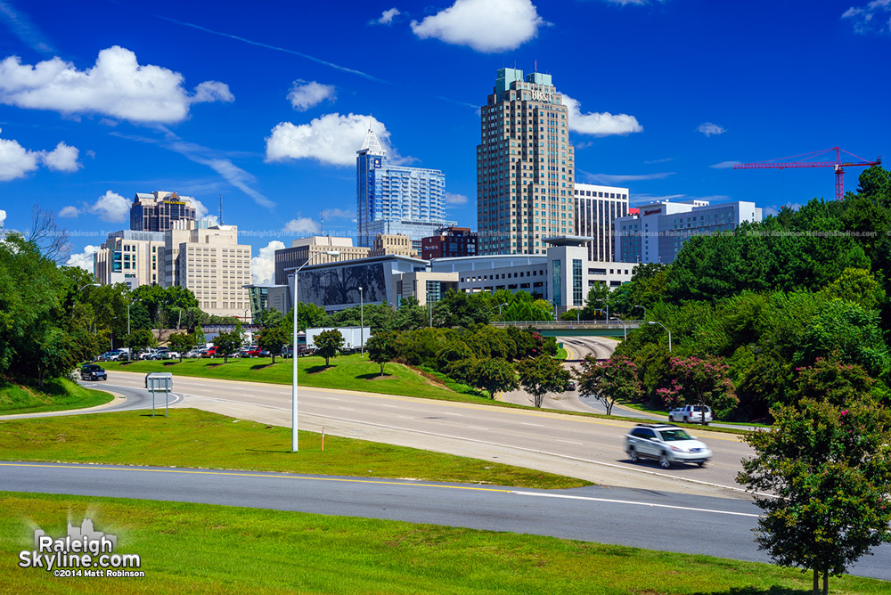 Blue Sky and Clouds with the Raleigh skyline from Western Boulevard