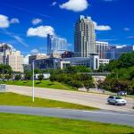 Blue Sky and Clouds with the Raleigh skyline from Western Boulevard