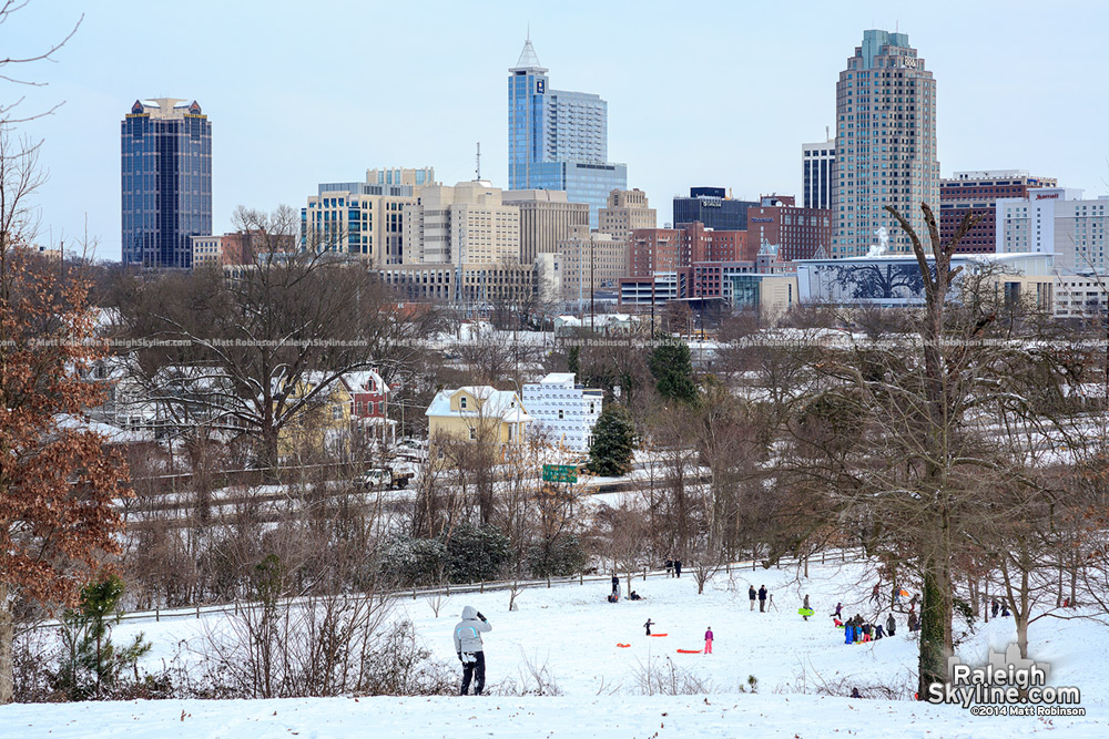 Sledders and Downtown Raleigh Skyline from Dorothea Dix