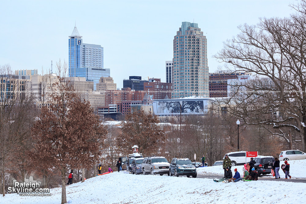 Downtown Raleigh on a snow day with sled riders