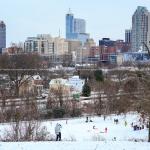 Sledders and Downtown Raleigh Skyline from Dorothea Dix