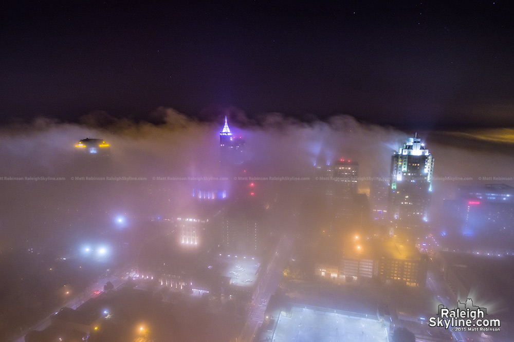 Raleigh buildings rise above fog at night