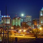 Full moon rise behind Raleigh Skyline