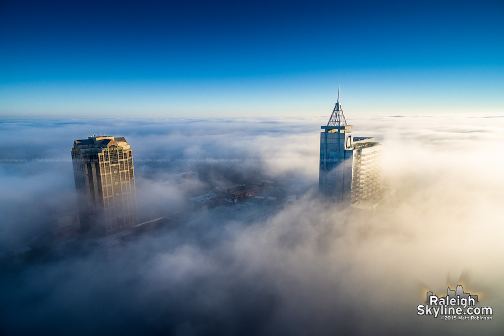 PNC Plaza and Wells Fargo Capitol Center above the fog