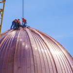 Workers atop the newest dome in Raleigh