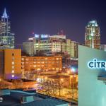 Citrix Sign with Downtown Raleigh at night