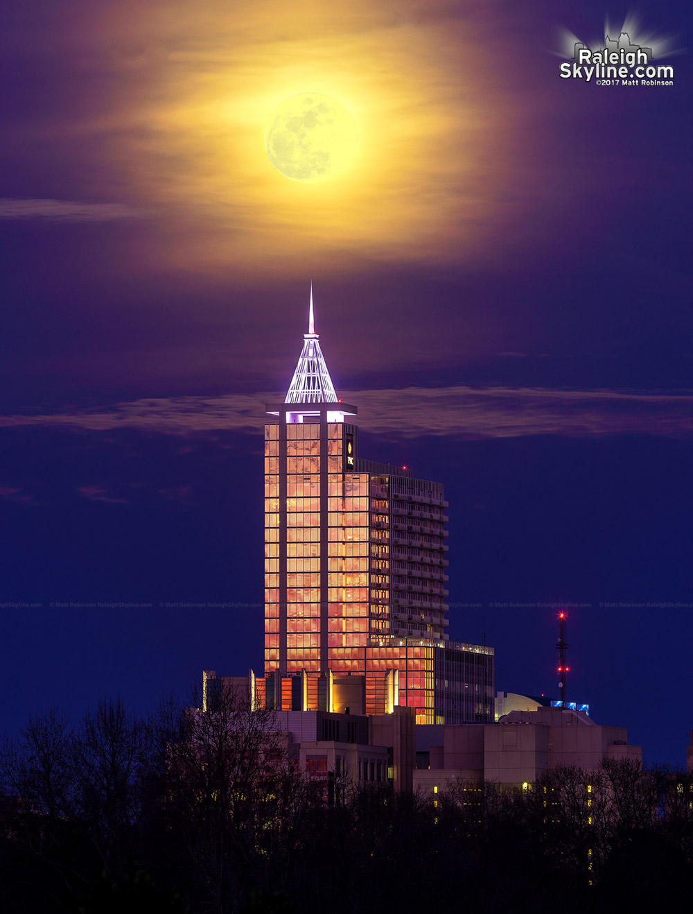 Full moon over PNC Plaza at sunset