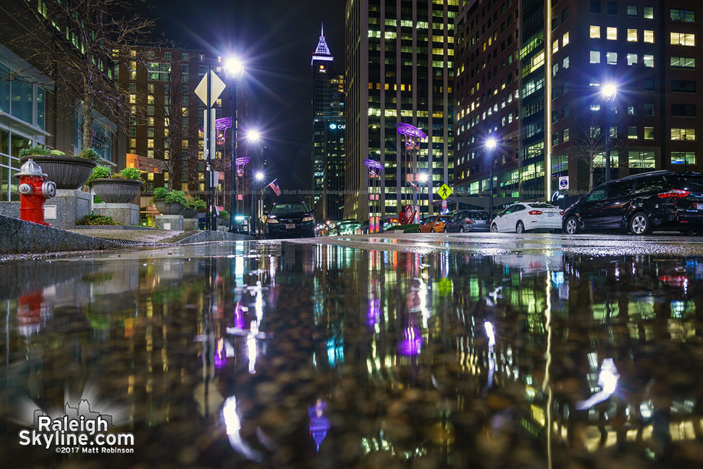 Puddles reflect Fayetteville Street