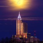 Full moon over PNC Plaza at sunset