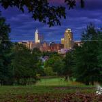 Early fall leaves at dusk with downtown Raleigh