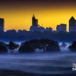 Sunrise colors behind the Raleigh skyline