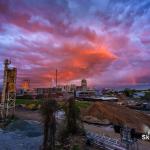 A fleeting rainbow appears with a vivid sunset over downtown Raleigh