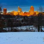 The setting sun illuminates downtown Raleigh in the snow