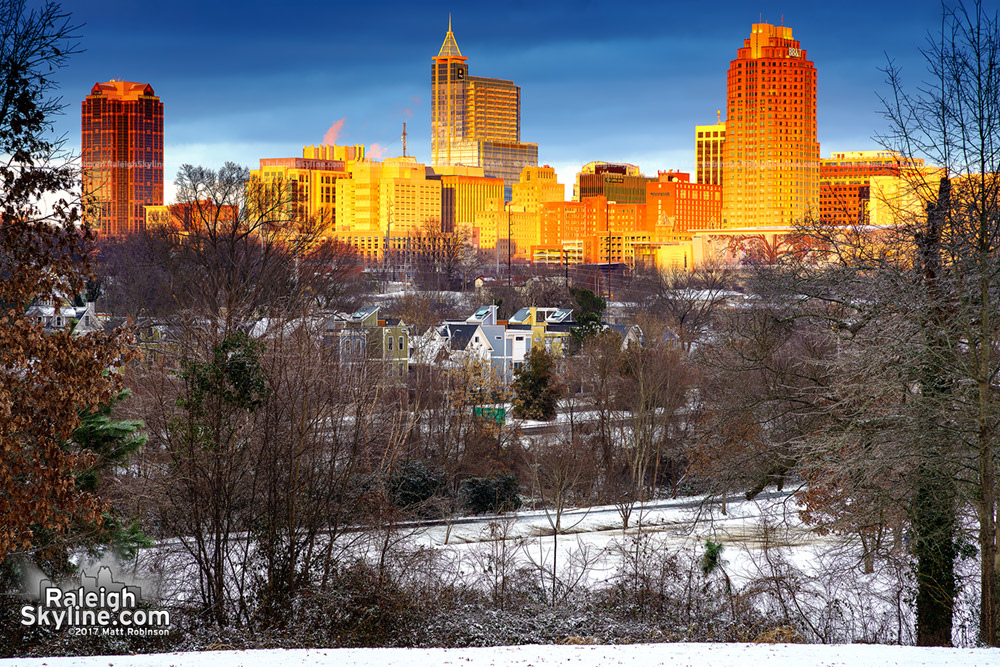 Sun illuminates the Raleigh Skyline from Dorothea Dix after snow