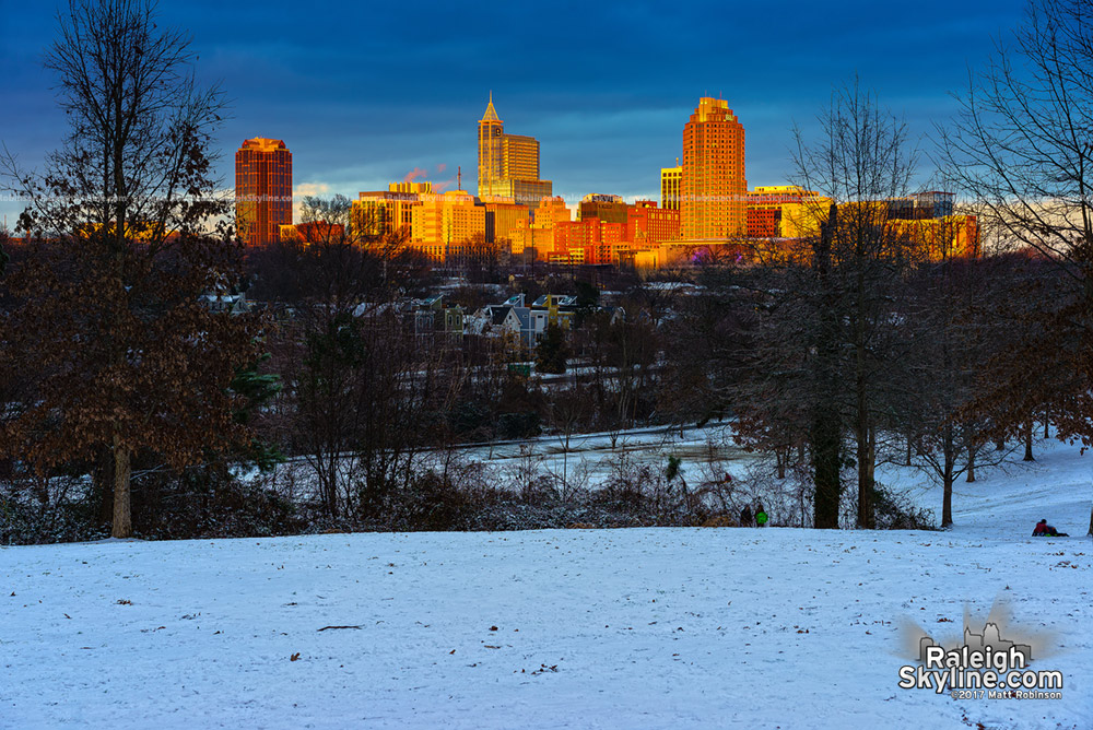 The setting sun illuminates downtown Raleigh in the snow