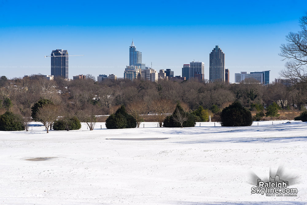 Bright sky and snow with downtown Raleigh