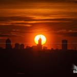 Sun sets directly behind Raleigh skyline from Knightdale