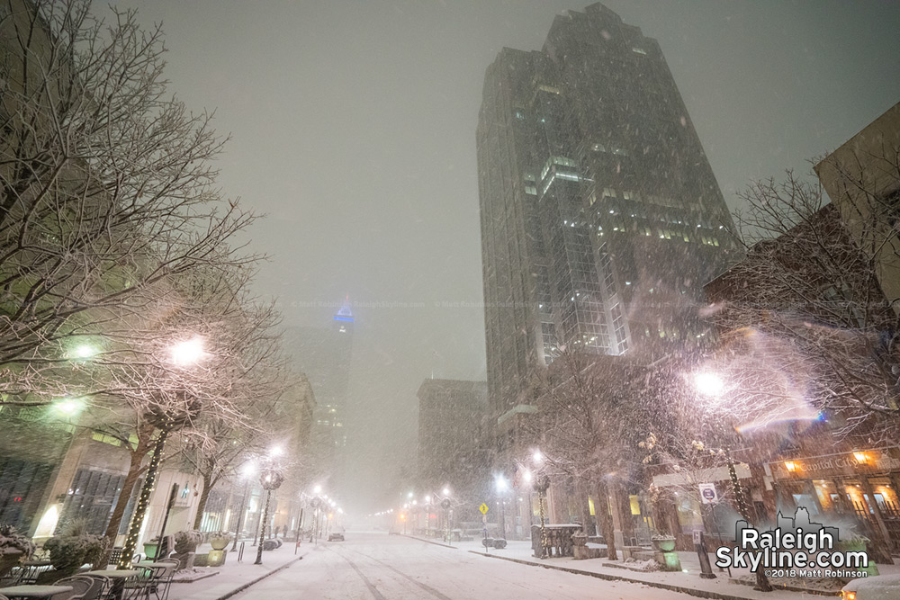 Looking up at snowfall in downtown Raleigh