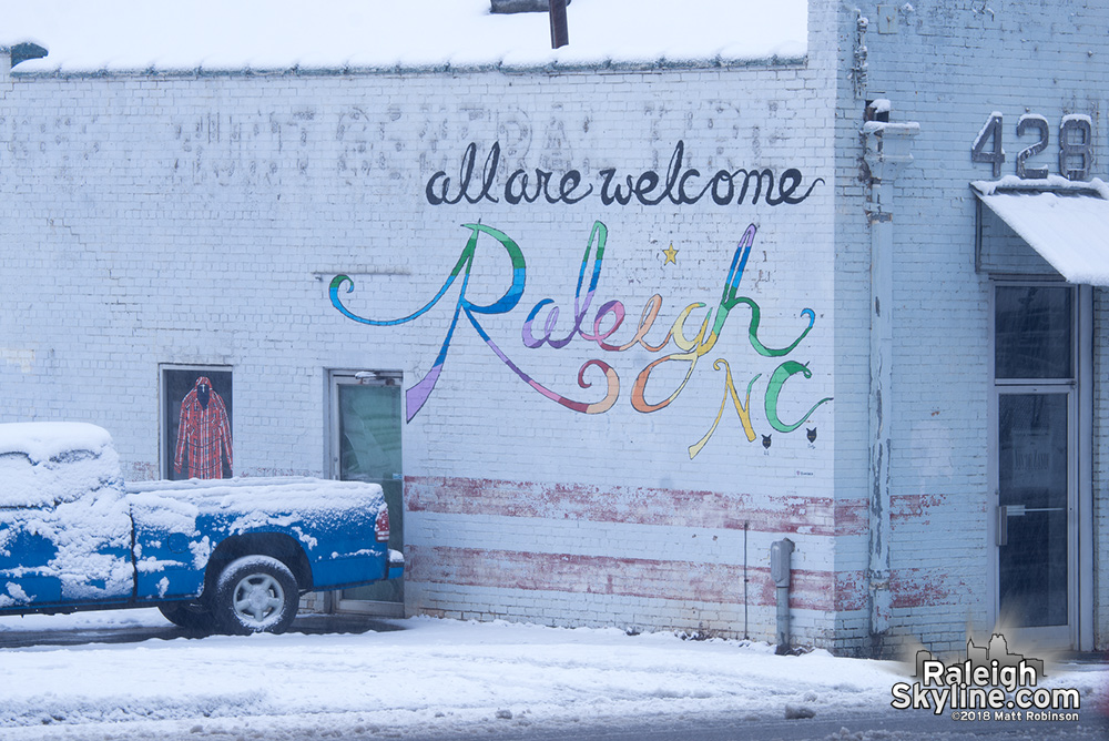 Raleigh All are Welcome sign in the snow