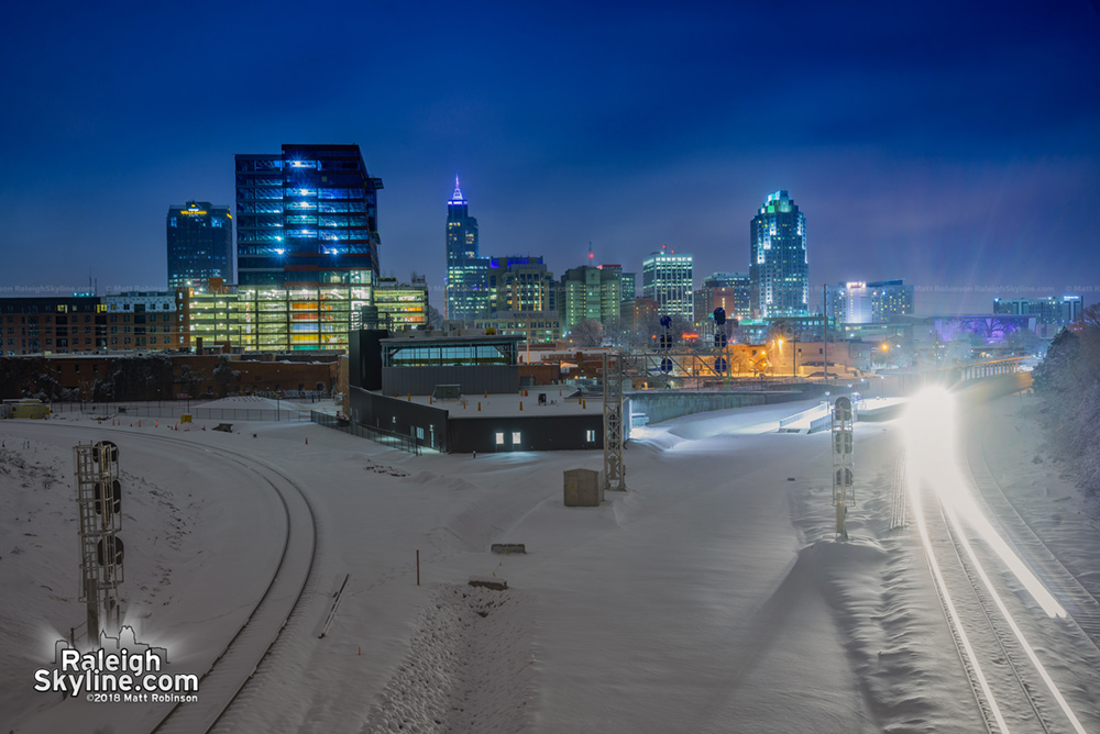 A lone train cuts through the snowy silence from Boylan Avenue.