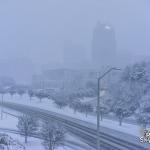 Snow begins to taper of as downtown slowy emerges