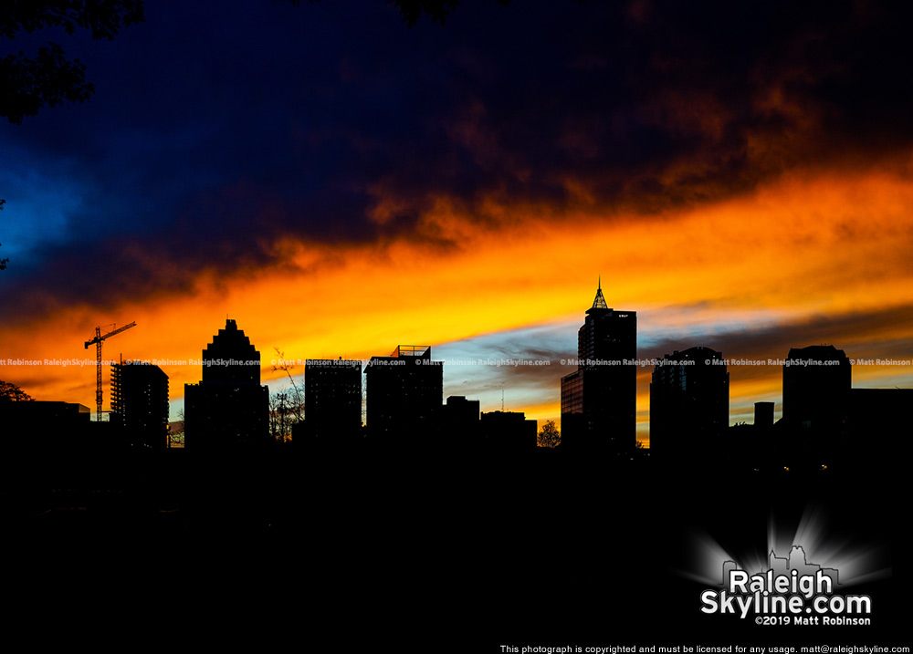 Vivid sunset with silhouetted Raleigh Skyline