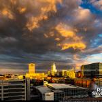 Sunlight underneath clouds with downtown Raleigh