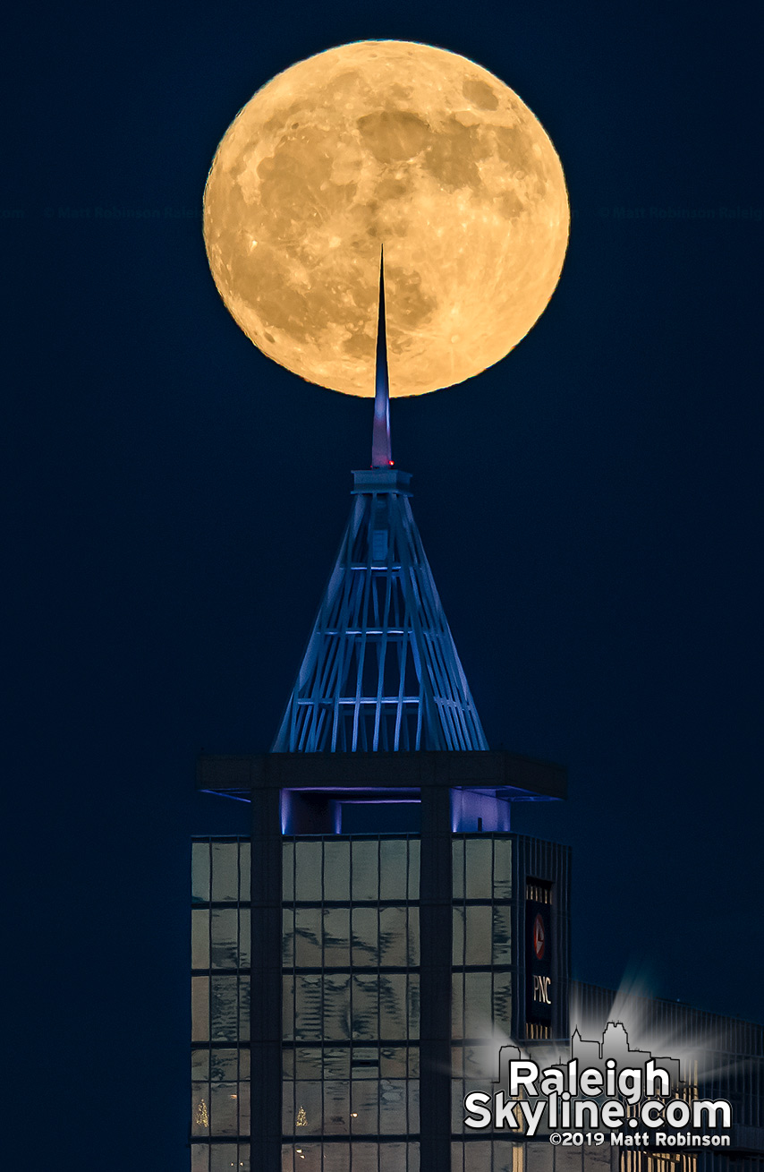 Spire of PNC Plaza pokes the full moon rising