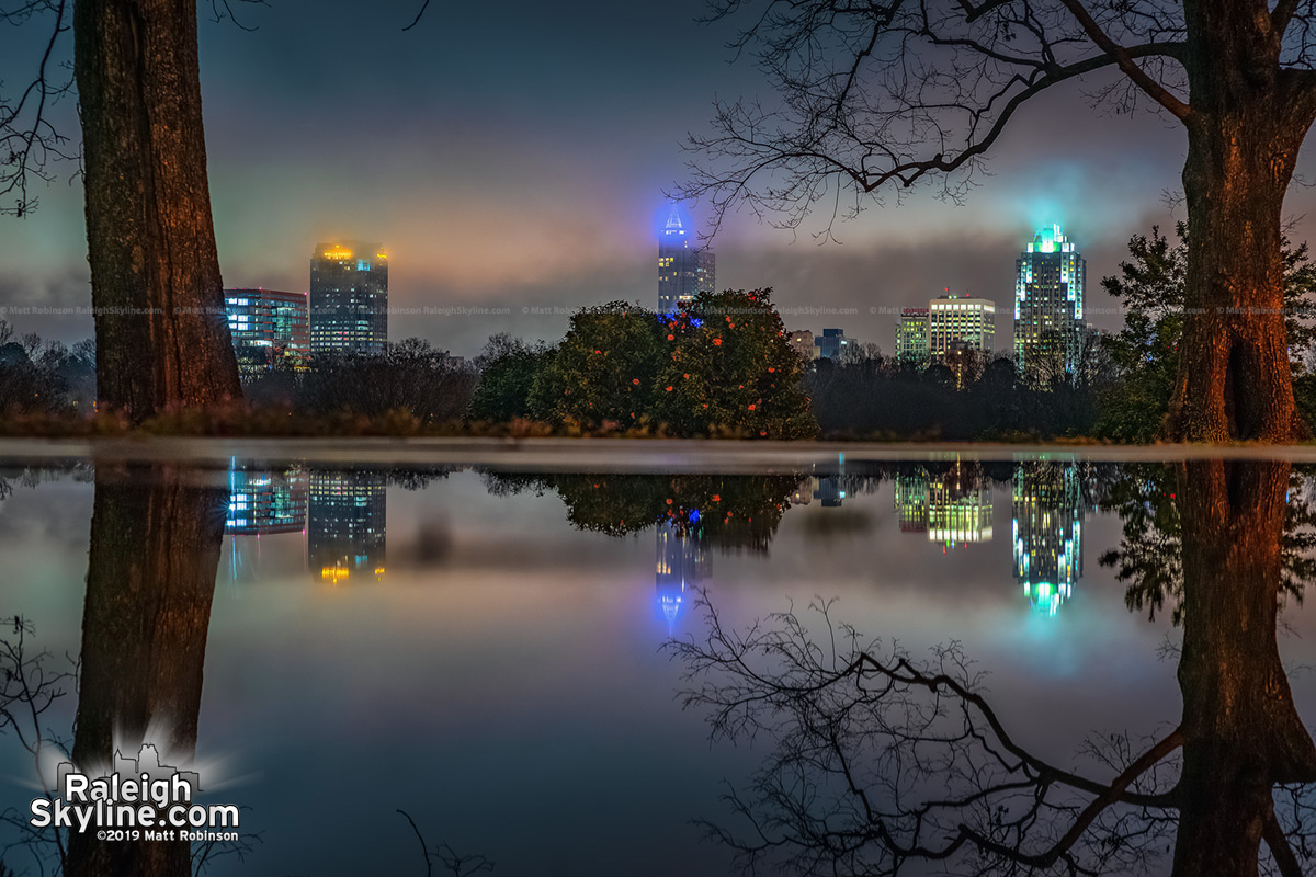 Large puddle reflects the Raleigh skyline at Dix Park