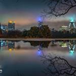 Large puddle reflects the Raleigh skyline at Dix Park