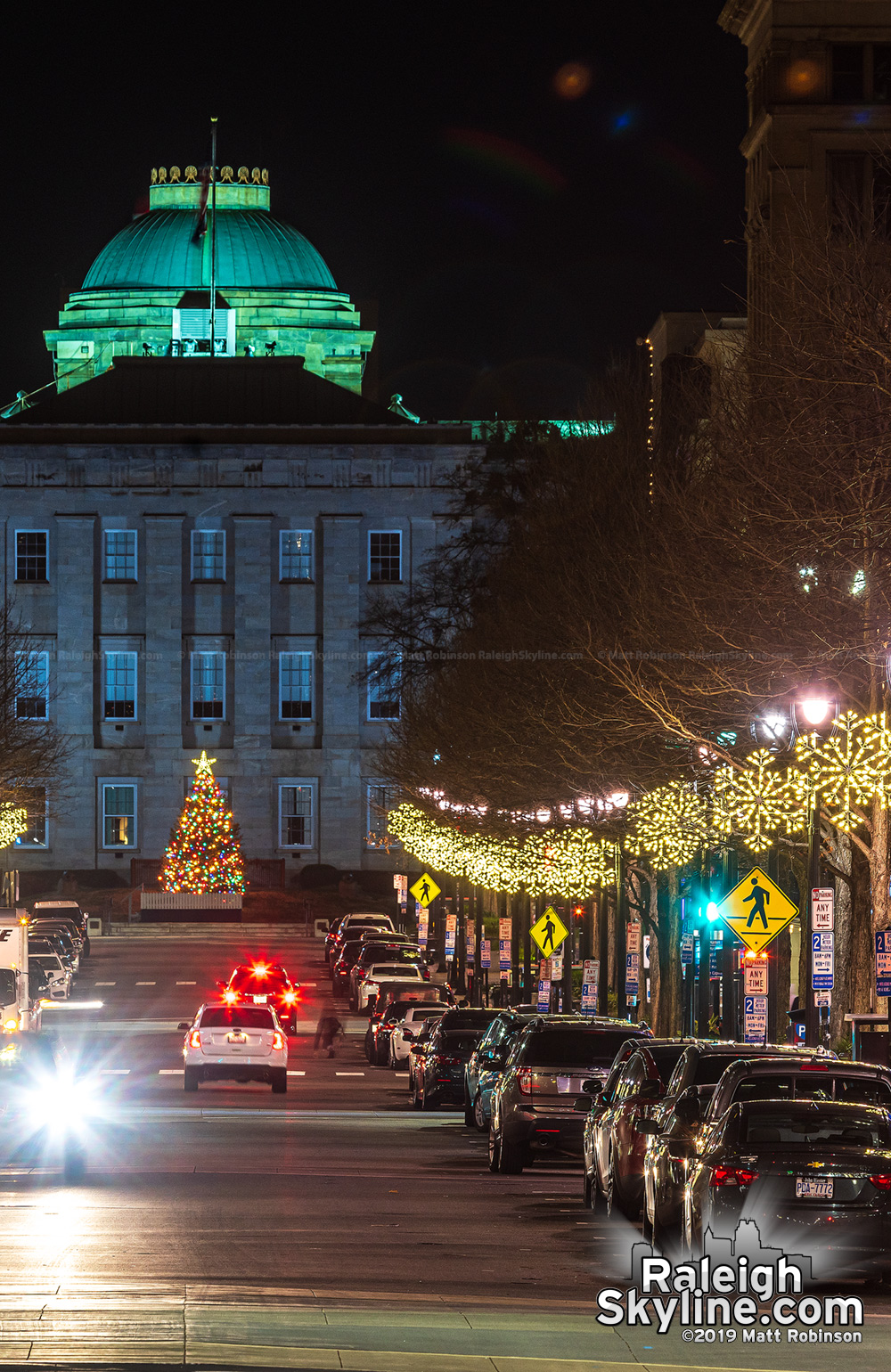 Looking down Fayetteville Street towards the lit NC State Capitol tree.