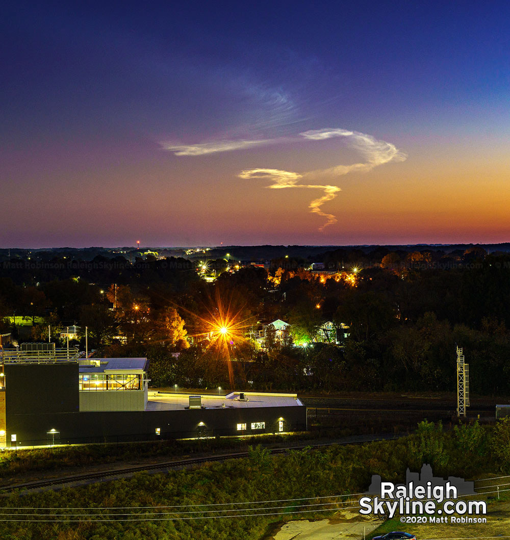 Rocket launch exhaust trail visible over downtown Raleigh