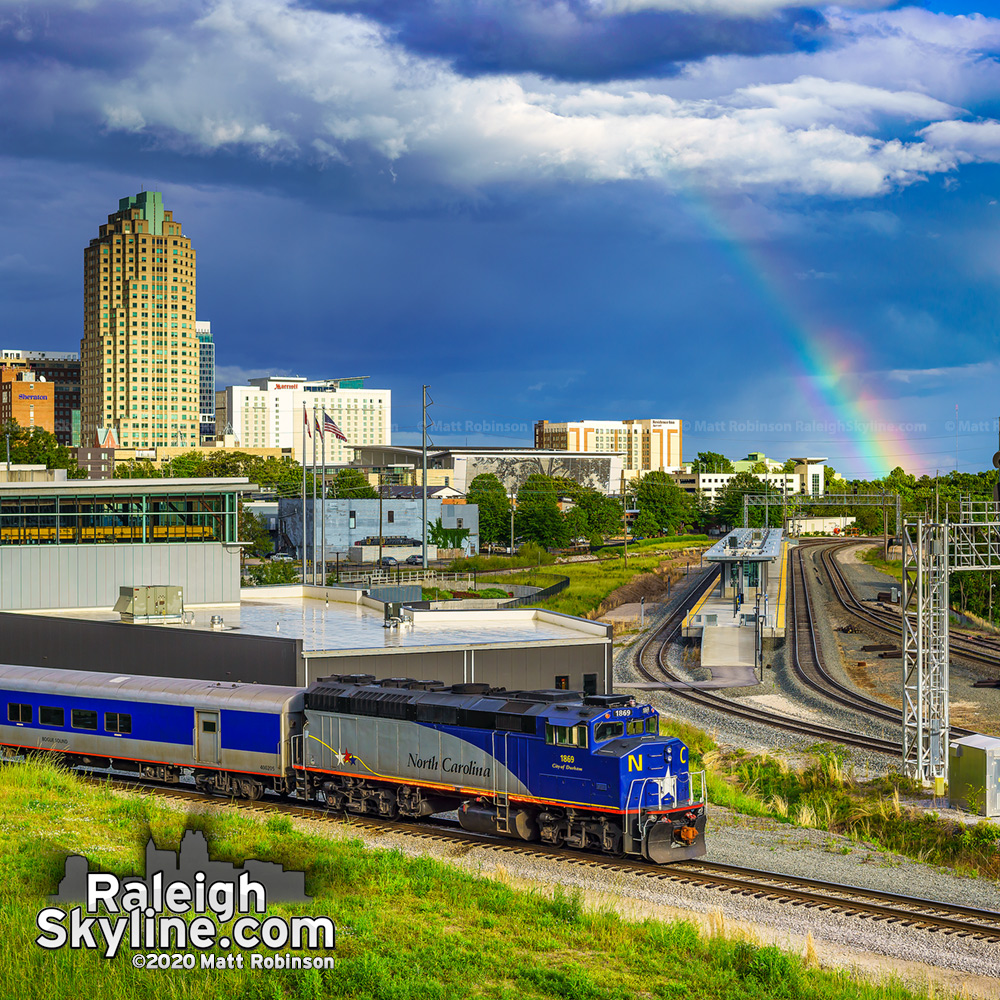 Late day rainbow in downtown Raleigh as the NCDOT City of Durham locomotive heads to the yard.