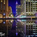 Downtown Raleigh reflecting in a large puddle on Fayetteville Street