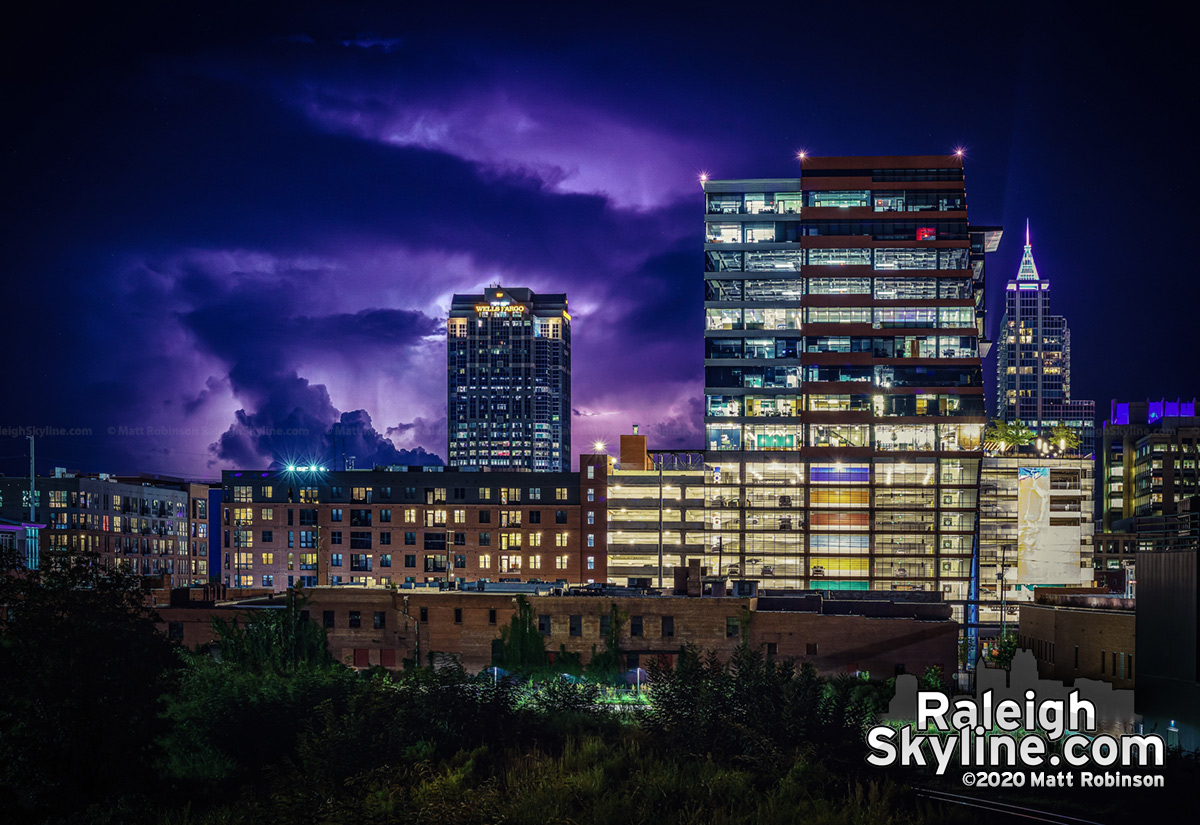 A thunderstorm over 40 miles away lights up the horizon behind downtown Raleigh