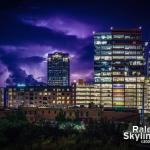 A thunderstorm over 40 miles away lights up the horizon behind downtown Raleigh