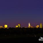 Downtown Raleigh windows reflect orange hues after sunset against the fall evening sky