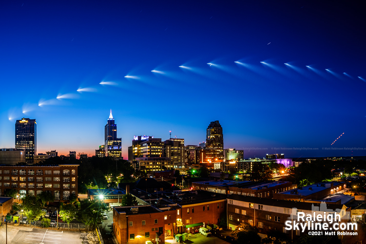 Image stack of the plume of the second stage of a SpaceX Falcon 9 rocket carrying NASA Crew 2 astronauts to the International Space Station is seen in the skies this morning over downtown Raleigh.