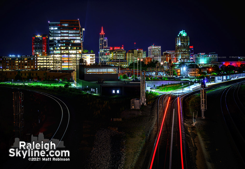 The red lights of an NCDOT locomotive add to the red-lit skyline of downtown Raleigh in support of the Carolina Hurricanes.