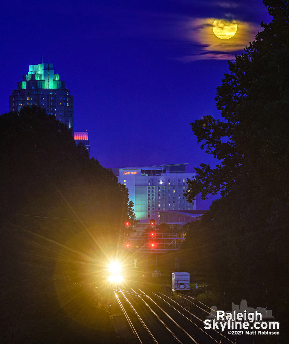 An approaching train doing its best to outshine the rising moon over Raleigh 