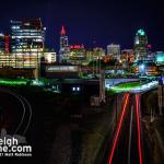 The red lights of an NCDOT locomotive add to the red-lit skyline of downtown Raleigh in support of the Carolina Hurricanes.